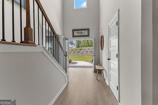 interior space with plenty of natural light, stairs, and a high ceiling