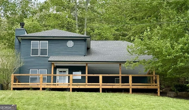 233 Bradshaw Rd, Hiawassee, GA 30546 - back of property with a lawn, a chimney, roof with shingles, and a wooden deck