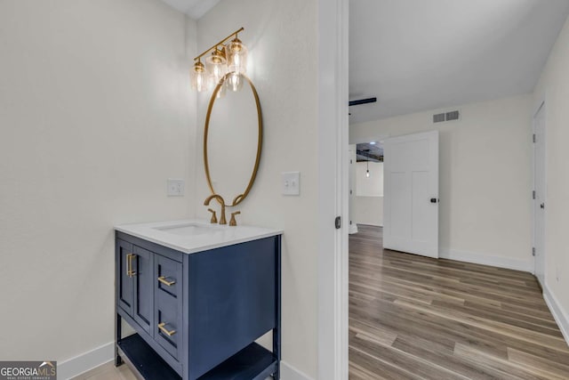 233 Bradshaw Rd, Hiawassee, GA 30546 - bathroom featuring baseboards, visible vents, wood finished floors, and vanity
