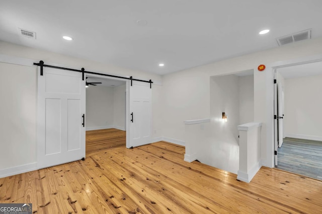 233 Bradshaw Rd, Hiawassee, GA 30546 - empty room with light wood-style flooring, a barn door, and visible vents