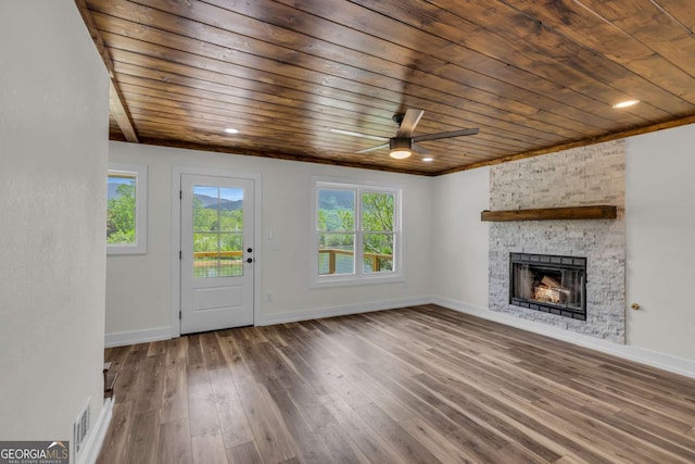 233 Bradshaw Rd, Hiawassee, GA 30546 - unfurnished living room featuring wood ceiling, a ceiling fan, a stone fireplace, visible vents, and hardwood / wood-style floors