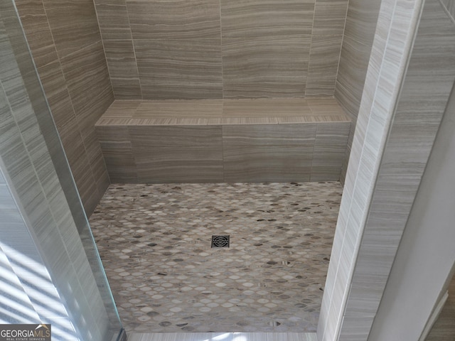 bathroom with tiled shower