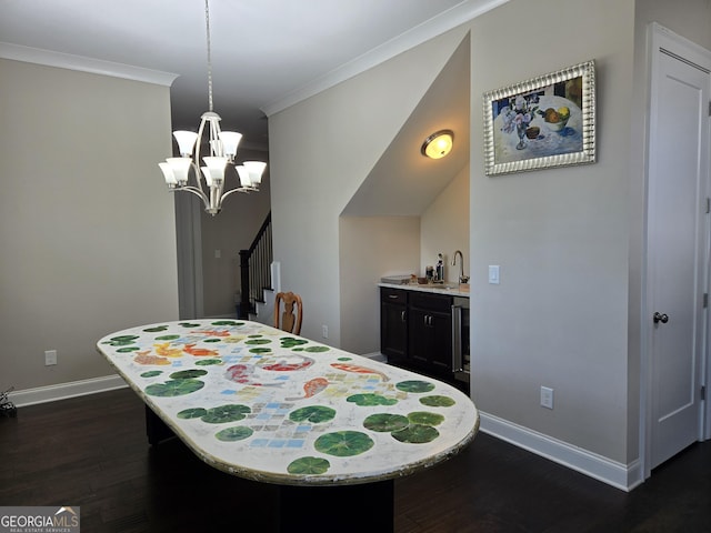 bedroom with indoor wet bar, ornamental molding, baseboards, and dark wood-style floors