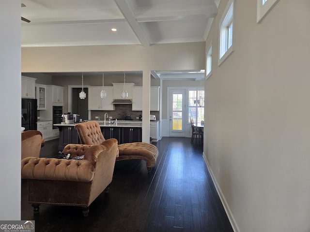living area featuring recessed lighting, baseboards, dark wood-type flooring, beamed ceiling, and coffered ceiling