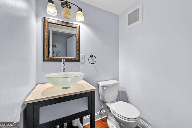 4608 Rosemear Ct, Norcross, GA 30093 - bathroom with visible vents, wood finished floors, baseboards, vanity, and toilet