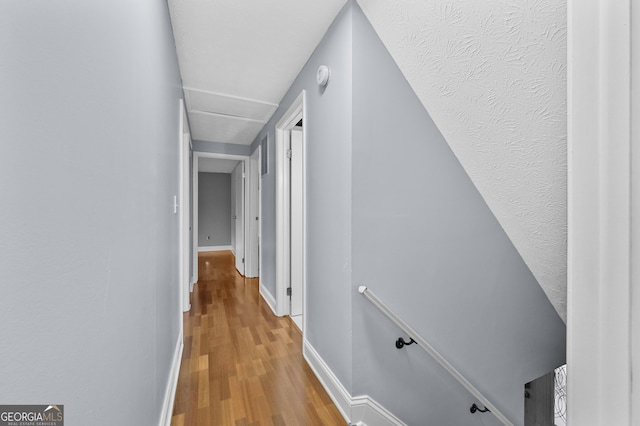 4608 Rosemear Ct, Norcross, GA 30093 - hallway featuring baseboards and wood finished floors