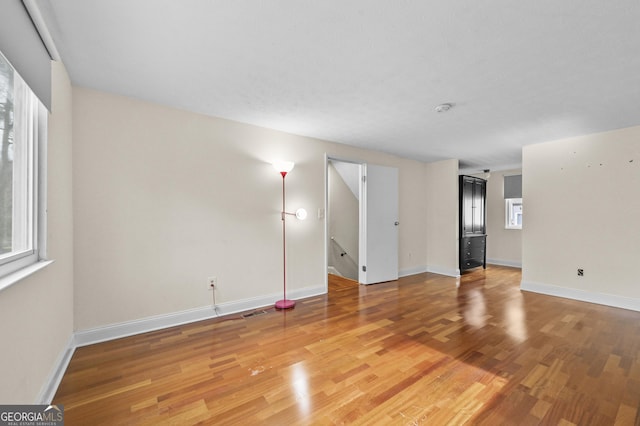 4608 Rosemear Ct, Norcross, GA 30093 - unfurnished living room featuring baseboards, plenty of natural light, and light wood finished floors
