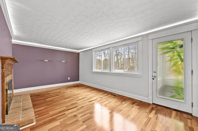 4608 Rosemear Ct, Norcross, GA 30093 - unfurnished living room featuring a textured ceiling, visible vents, wood finished floors, and a fireplace