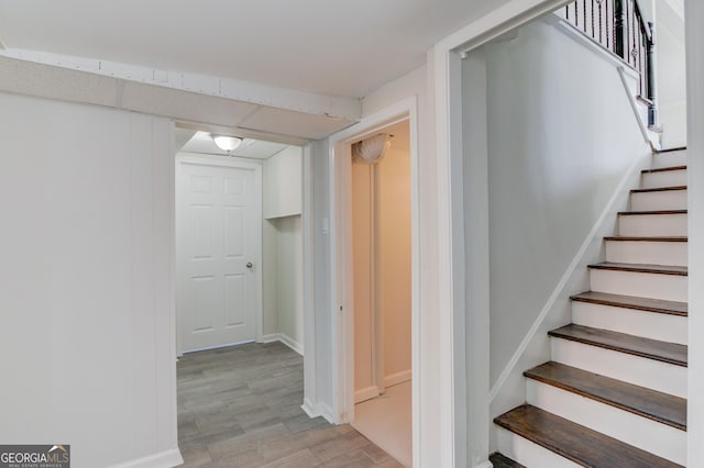 stairs featuring baseboards and wood finished floors