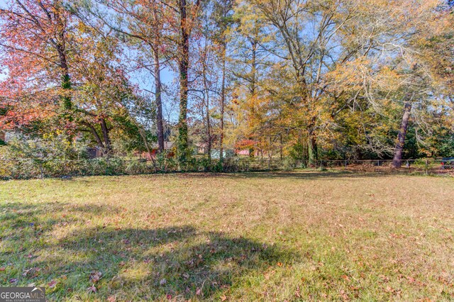 2103 Columbia Dr, Decatur, GA 30032 - back of house featuring brick siding, a yard, fence, and board and batten siding