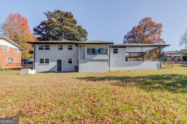 2103 Columbia Dr, Decatur, GA 30032 - rear view of property featuring brick siding, fence, and a lawn