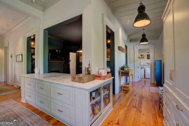 hall with light wood-type flooring and crown molding