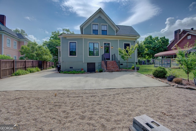 view of front of home with fence and crawl space