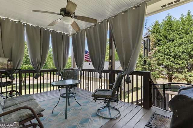 wooden deck featuring ceiling fan