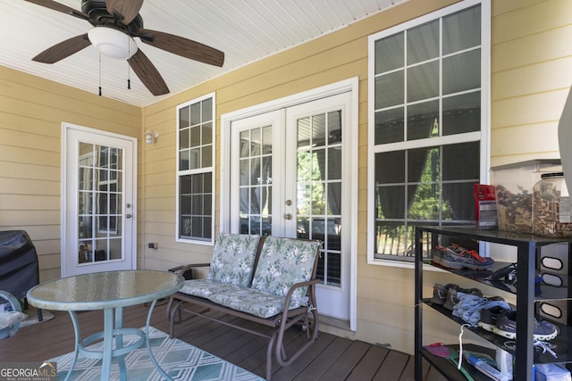 wooden terrace featuring french doors and a ceiling fan