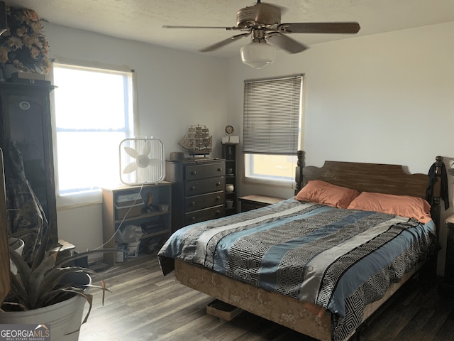 bedroom with a ceiling fan and wood finished floors