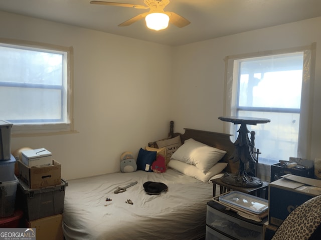 bedroom featuring multiple windows and ceiling fan
