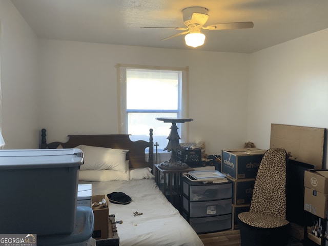 bedroom with ceiling fan and dark wood finished floors