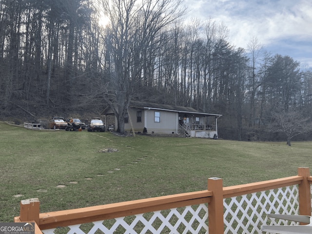 view of yard with a porch and fence