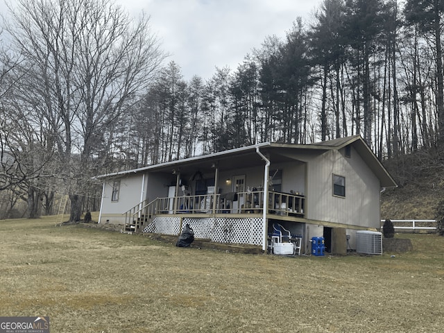 view of front facade with central air condition unit, a porch, and a front lawn