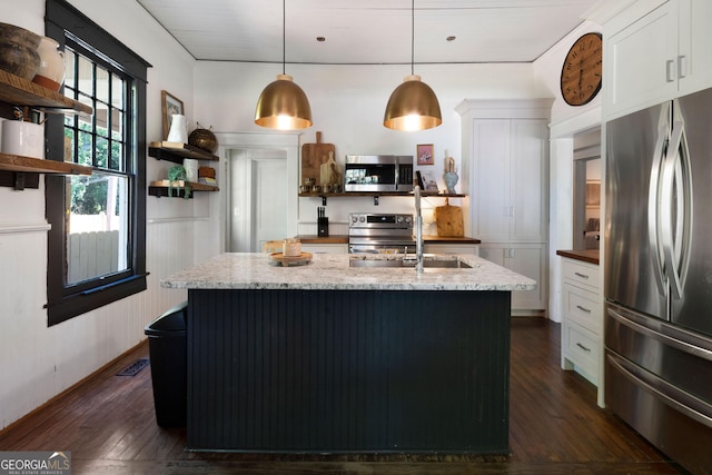 kitchen featuring stainless steel appliances, open shelves, a sink, dark wood-style flooring, and white cabinetry
