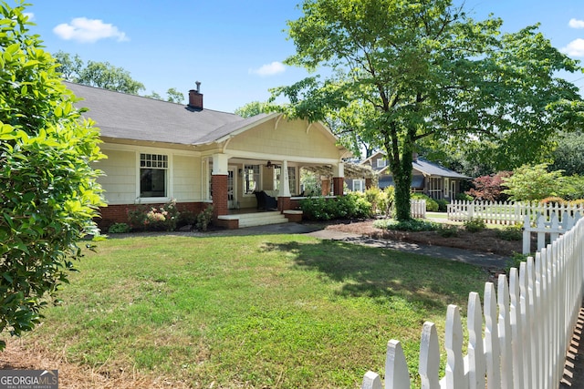 view of front of property with a porch, a chimney, and brick siding