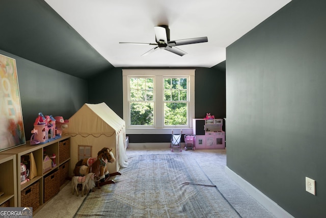 recreation room with carpet floors, a ceiling fan, lofted ceiling, and baseboards