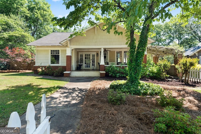 craftsman inspired home with brick siding, a porch, and french doors