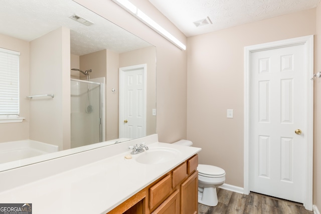 314 Meadows Ln, Canton, GA 30114 - full bath with a stall shower, wood finished floors, toilet, vanity, and a textured ceiling