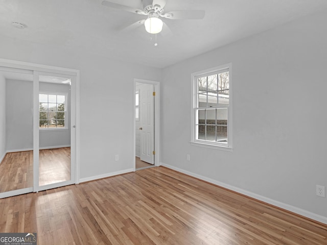 unfurnished bedroom featuring baseboards, light wood-style flooring, and ceiling fan