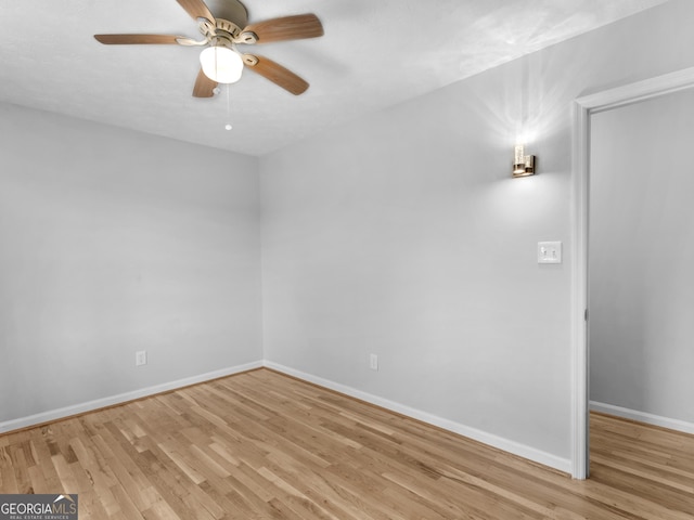 unfurnished room with baseboards, ceiling fan, and light wood-style floors