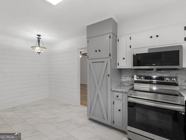 kitchen with marble finish floor, white cabinets, tasteful backsplash, hanging light fixtures, and stainless steel appliances