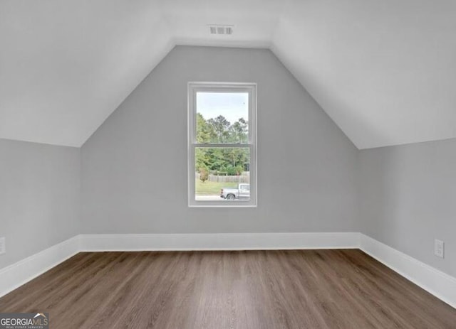 3312 Mill Forest Dr, Conyers, GA 30094 - additional living space featuring baseboards, lofted ceiling, wood finished floors, and visible vents