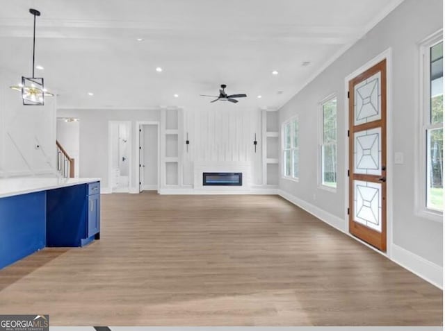 3312 Mill Forest Dr, Conyers, GA 30094 - unfurnished living room featuring a glass covered fireplace, baseboards, recessed lighting, and light wood-style flooring