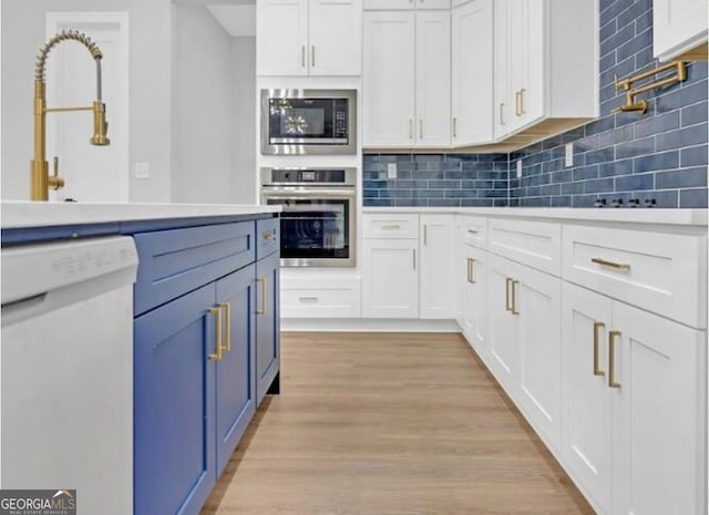 3312 Mill Forest Dr, Conyers, GA 30094 - kitchen with decorative backsplash, white cabinets, and stainless steel appliances