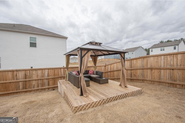 view of yard featuring an outdoor living space, a fenced backyard, a wooden deck, and a gazebo