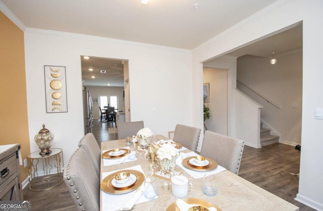 dining space with ornamental molding, stairs, and wood finished floors