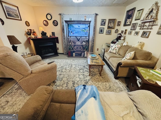 living room with carpet floors, a fireplace, and a textured ceiling