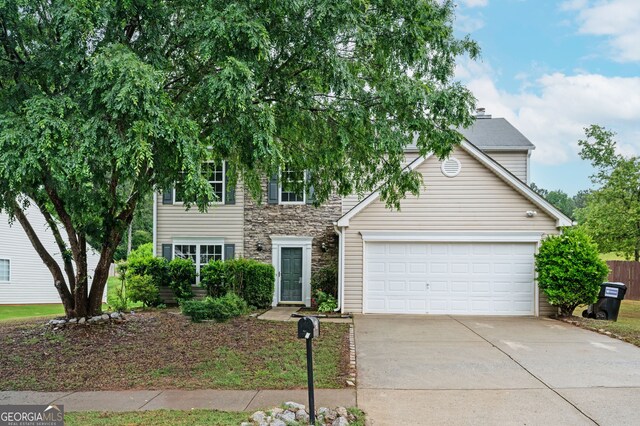 3230 Deer Valley Dr NW, Acworth, GA 30101 - view of front facade featuring concrete driveway, an attached garage, and stone siding