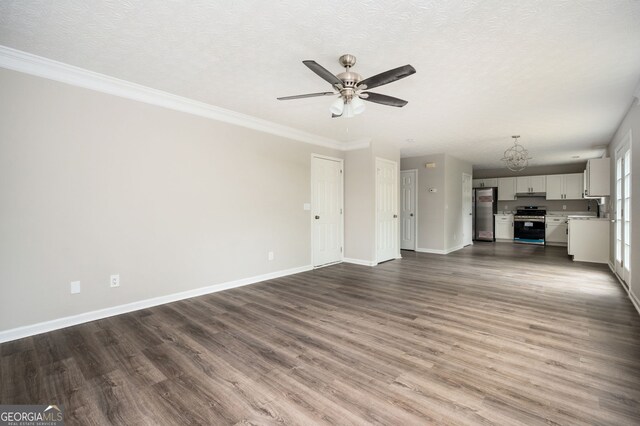 3230 Deer Valley Dr NW, Acworth, GA 30101 - unfurnished living room featuring a chandelier, dark wood-style floors, a ceiling fan, baseboards, and a textured ceiling