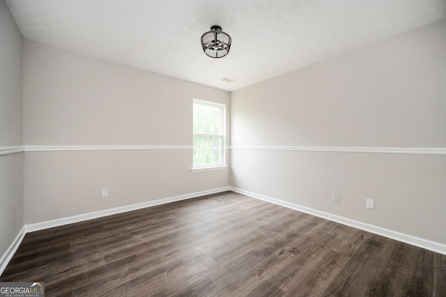 3230 Deer Valley Dr NW, Acworth, GA 30101 - spare room featuring dark wood finished floors, baseboards, and a textured ceiling