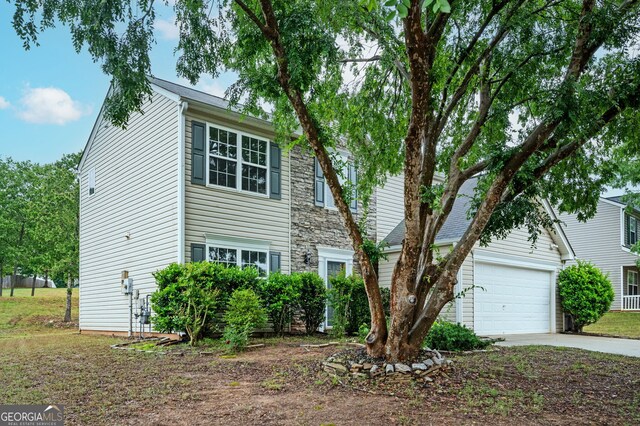 3230 Deer Valley Dr NW, Acworth, GA 30101 - traditional home featuring concrete driveway, stone siding, and an attached garage