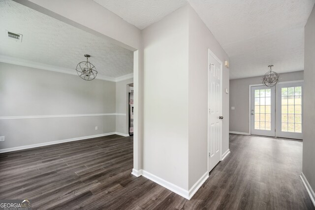 3230 Deer Valley Dr NW, Acworth, GA 30101 - empty room with a chandelier, a textured ceiling, dark wood-style floors, and baseboards