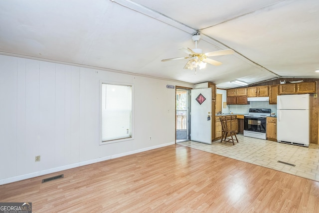 unfurnished living room with visible vents, a ceiling fan, light wood finished floors, and baseboards