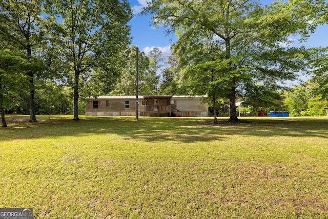 view of yard with a wooden deck