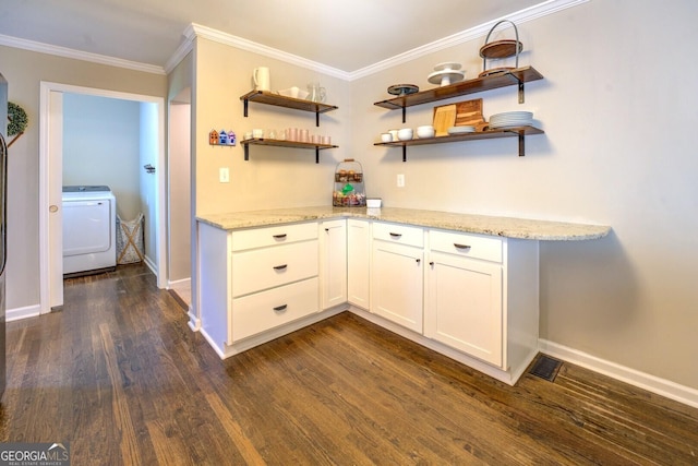 interior space with open shelves, dark wood finished floors, washer / clothes dryer, and light stone countertops