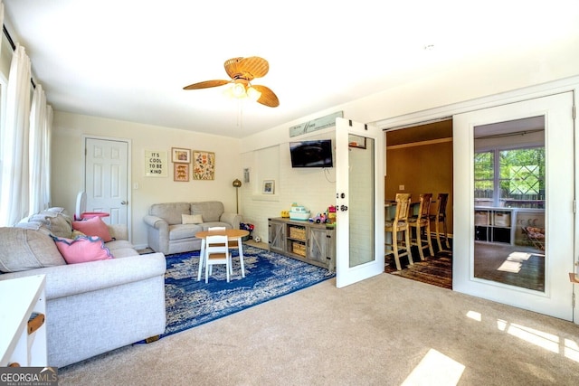 carpeted living room with a ceiling fan