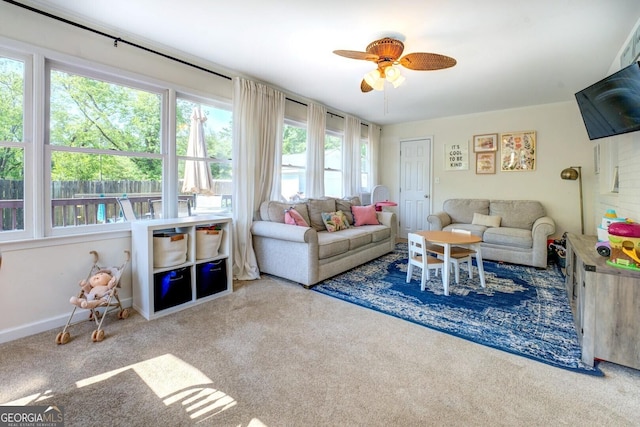 carpeted living room with a ceiling fan
