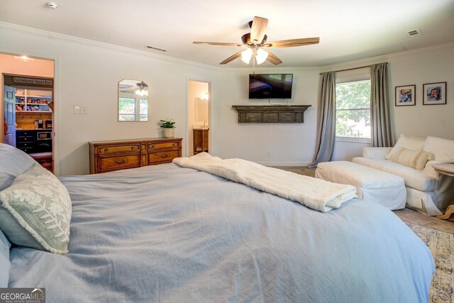 5327 David Cir SE, Covington, GA 30014 - bedroom with ornamental molding, a walk in closet, a ceiling fan, connected bathroom, and baseboards