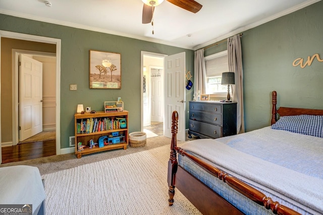 carpeted bedroom with crown molding, a ceiling fan, and baseboards